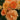 Close-up of peach-orange roses with layered petals and small buds, set against a blurred green garden background.