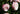 Two pale pink roses with white centers blooming among dark green leaves in a garden setting.