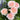 Close-up of a large cluster of light pink roses with green leaves in the background and purple saliva