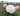 A close-up of a pale blush pink rose in full bloom, with two matching pink rose buds and green leaves, set against a softly blurred garden background.